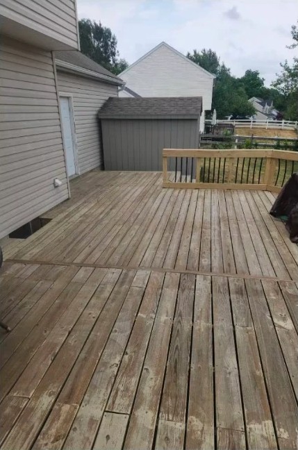 Before deck staining: weathered gray deck boards